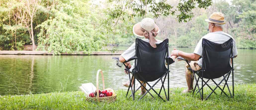 Elder couple sitting by a lake